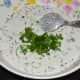 Add the finely chopped coriander leaves. The batter should have idli batter consistency. Add water if needed. Mix well.
