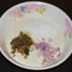 Add the grated coconut, finely chopped onions, and seasonings as per instructions. Thoroughly mix the batter.
