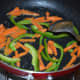 Step one: Prepare the topping. For this, saute julienned carrots and capsicum in butter.