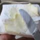 Butter paper towel to grease inside of pan.