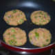 Step three: Take a lemon-sized portion of the mixture. Shape it like a patty. Make 4 such shapes. Shallow-fry them in a pan.
