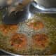 Step four: Deep-fry them on a medium high heat till they are dark brown. Transfer them to a plate with an absorbent paper towel to get rid of the excess oil.