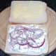 Onion and chive cottage cheese and red onion strands on bread