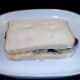 Second slice of bread completes assembly of steak and crisp sandwich