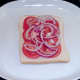 Red onion strands top tomato