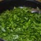 Step five: Throw in chopped spinach. Stir-cook on a high heat till they become soft.