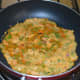3. Heat a griddle or flat pan. Pour on about four tablespoons of this batter. Spread it evenly to make a thick disc.