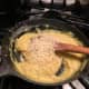 Add beaten egg yolks and Parmesan cheese to the sauce.