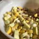 add yellow squash, onion and bread cubes to a medium size bowl and mix well