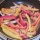 Peppers and onion are gently sauteed in oil