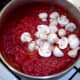 Onions added to spicy tomato sauce