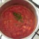 Canned tomatoes and chilli are added to softened onion