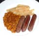 Venison sausages, chips and beans are plated