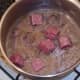 Venison sausage pieces are added to cooked and cooled steak