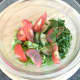 Salad ingredients are added to dressing