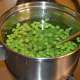 Step four: Add green peas. Keep the heat high. Stir it. Turn off the heat after two minutes.