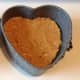 Biscuits and peanut butter paste inside the heart springform