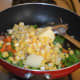 Step three: Add corn kernels and butter.