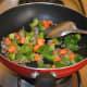 Step two: Add chopped vegetables as per instructions. Throw in some salt. Stir-cook for 3-4 minutes.
