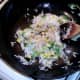 Light soy sauce is sprinkled over stir frying rice