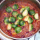 Halved sprouts are added to chilli