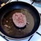 Burger is turned to fry on second side