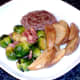Plated burger, sprouts, bacon and wedges
