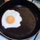 Egg is added to hot frying pan