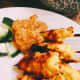The chicken satay is ready. Serve with fresh-cut cucumber and peanut sauce. 