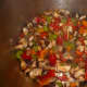 Sauté all the veggies together, then add the browned beef cubes, stock, wine, and herbs.