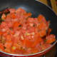 Step two: Add tomatoes. Throw in some salt. Stir-cook over medium high heat until tomatoes become mushy.