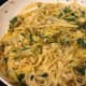 Skillet with white wine fettuccine, baby greens, and golden beets