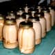 14 finished jars, sitting on a towel to cool overnight. See the gooey milk stuck to some of them? It's actually a form of cheese, because of contact with the vinegar.