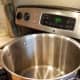 Clean your canner with soap and water, replace your jar rack, and half fill it with water.
