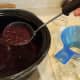 Ladle your jam into your jars up to the necks.