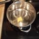 Start by melting butter in a large pot and a saute pan.