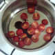Tomato sauce ingredients are added to a small saucepan