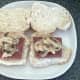 Garlic mushrooms and onions are spooned on to sausages on rolls