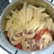 Penne pasta is added to garlic mushrooms and chicken sauce