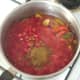 Tomatoes and seasonings are added to softened vegetables