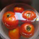 Tomatoes soaking in very hot water.