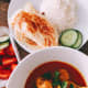 Chicken curry is ready with steamed white rice and roti. Perfect for dinner.