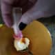 Simply use food coloring to turn your icing orange. Spread on cinnamon roll to create jack-o-lantern cinnamon rolls.