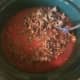Once ground beef is browned, put in the crock-pot. Do not drain the grease.
