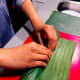 Tightly roll the banana leaf from the bottom. 
