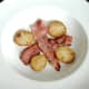 Plated bacon and potato slices