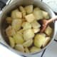 Apples, pineapples and mincemeat are stirred over heat