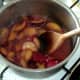 Plums are stirred frequently as they stew