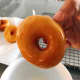 Dip the donut into the sugar glaze mixture. 
