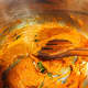 Add the curry powder. Keep stirring for a few minutes until the oil surfaces on top of the paste. 